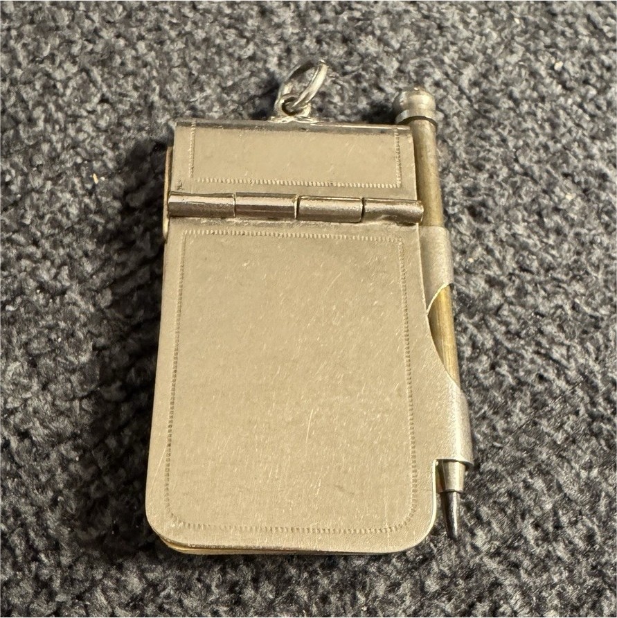 This is an antique aide-mémoire, a miniature notepad and pencil set 
