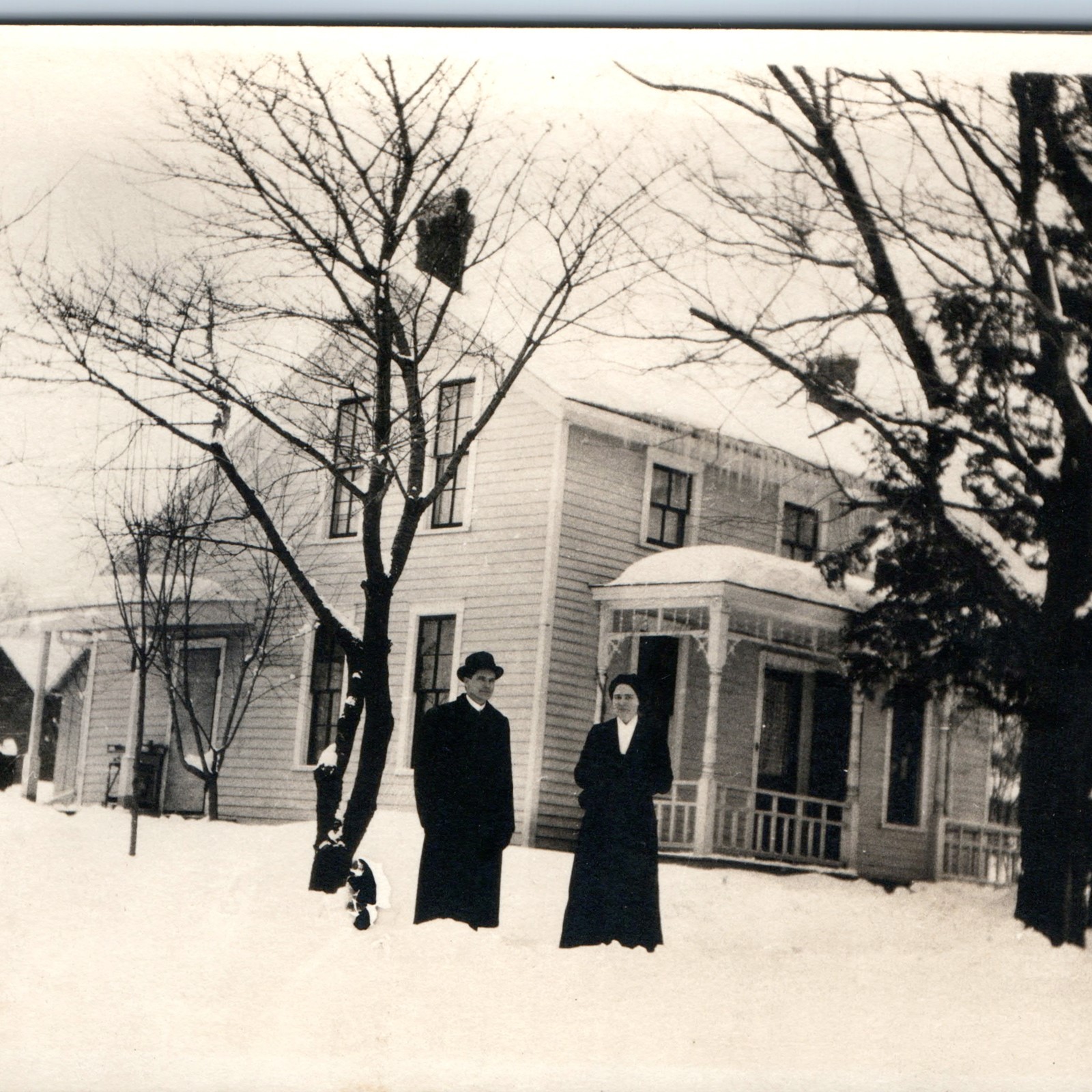 c1910s Outdoor Winter Couple RPPC Snowy House Porch Trees Yard Real Photo PC