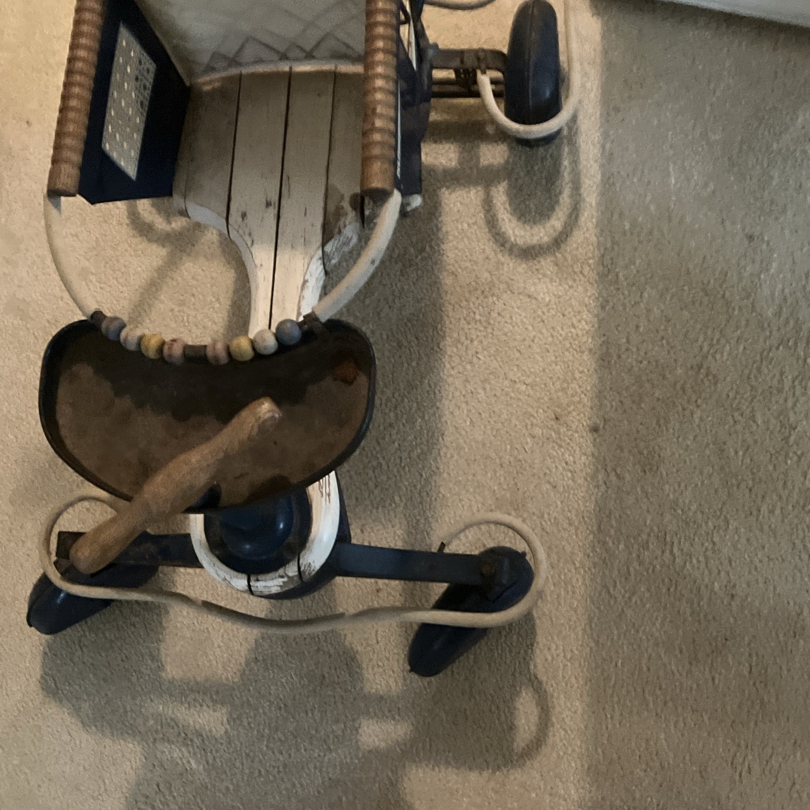 An Antique Baby Stroller with Wheels