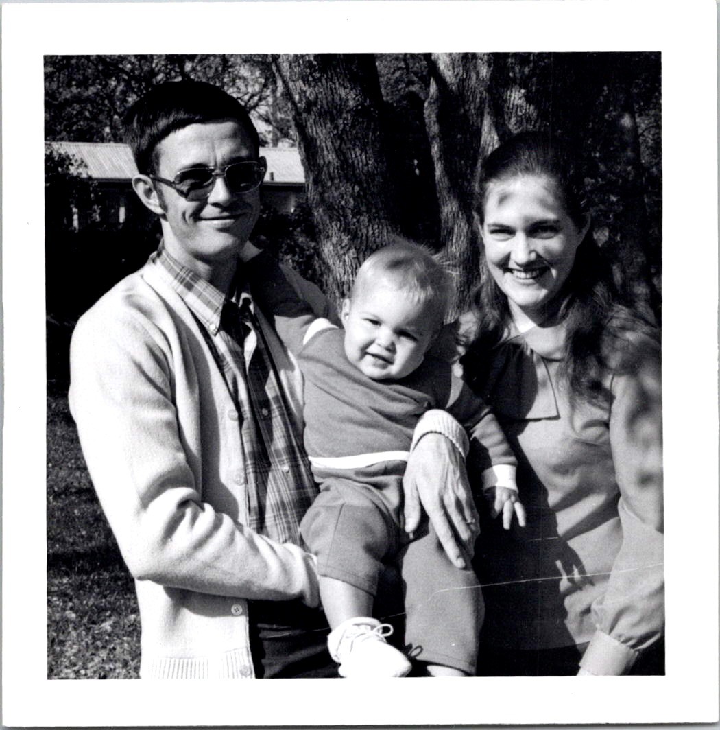 Smiling Young Family with Baby Outdoors, 1970s B&W Snapshot Photo