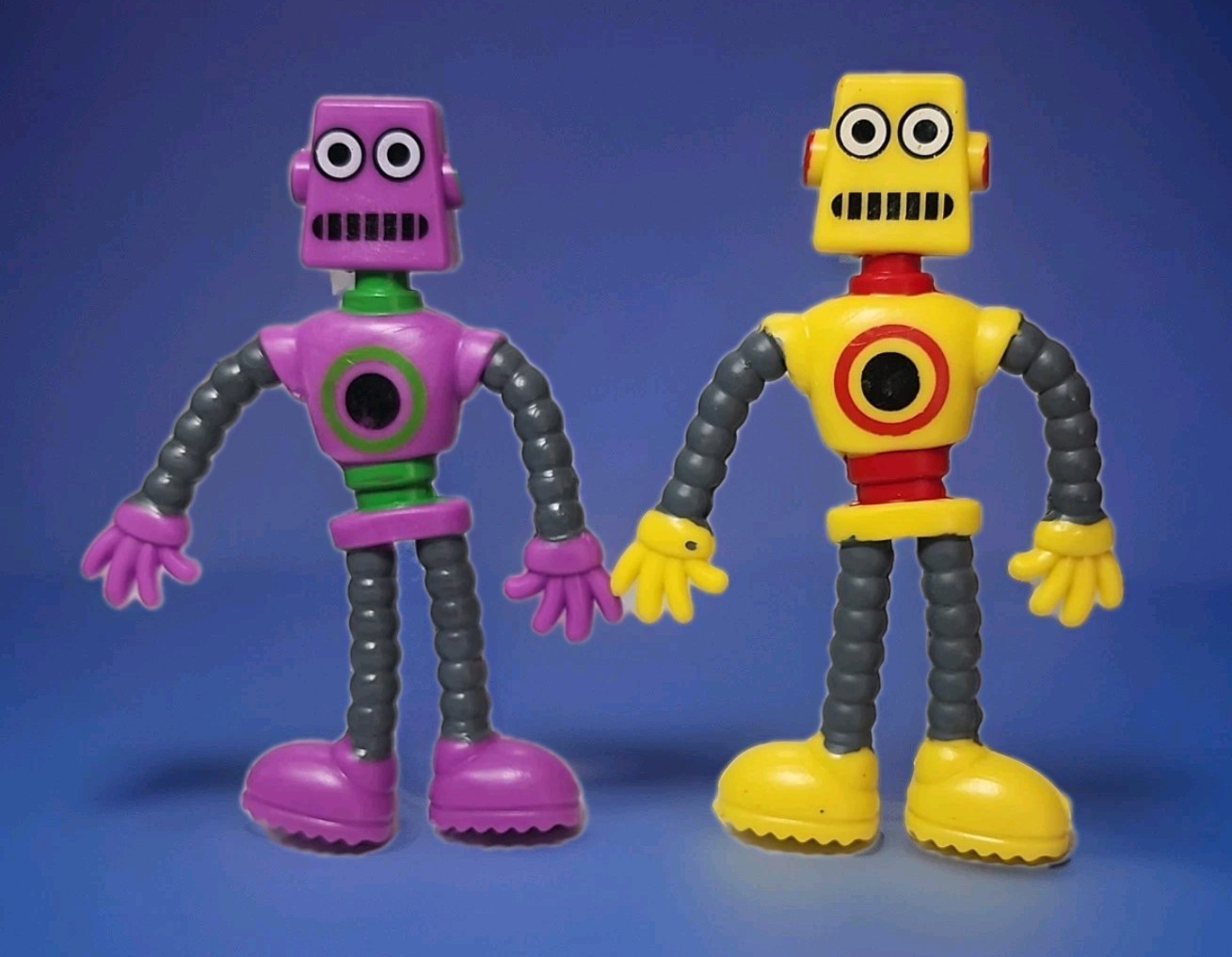 2 KEYCRAFT BENDY ROBOTS POCKET MONEY FINGER FIDGET TOOLS YELLOW & PURPLE 3¾\