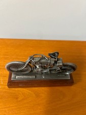 pewter replica of the Harley-Davidson Serial Number One motorcycle mounted on a picture