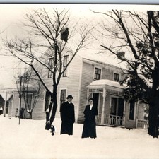 c1910s Outdoor Winter Couple RPPC Snowy House Porch Trees Yard Real Photo PC picture